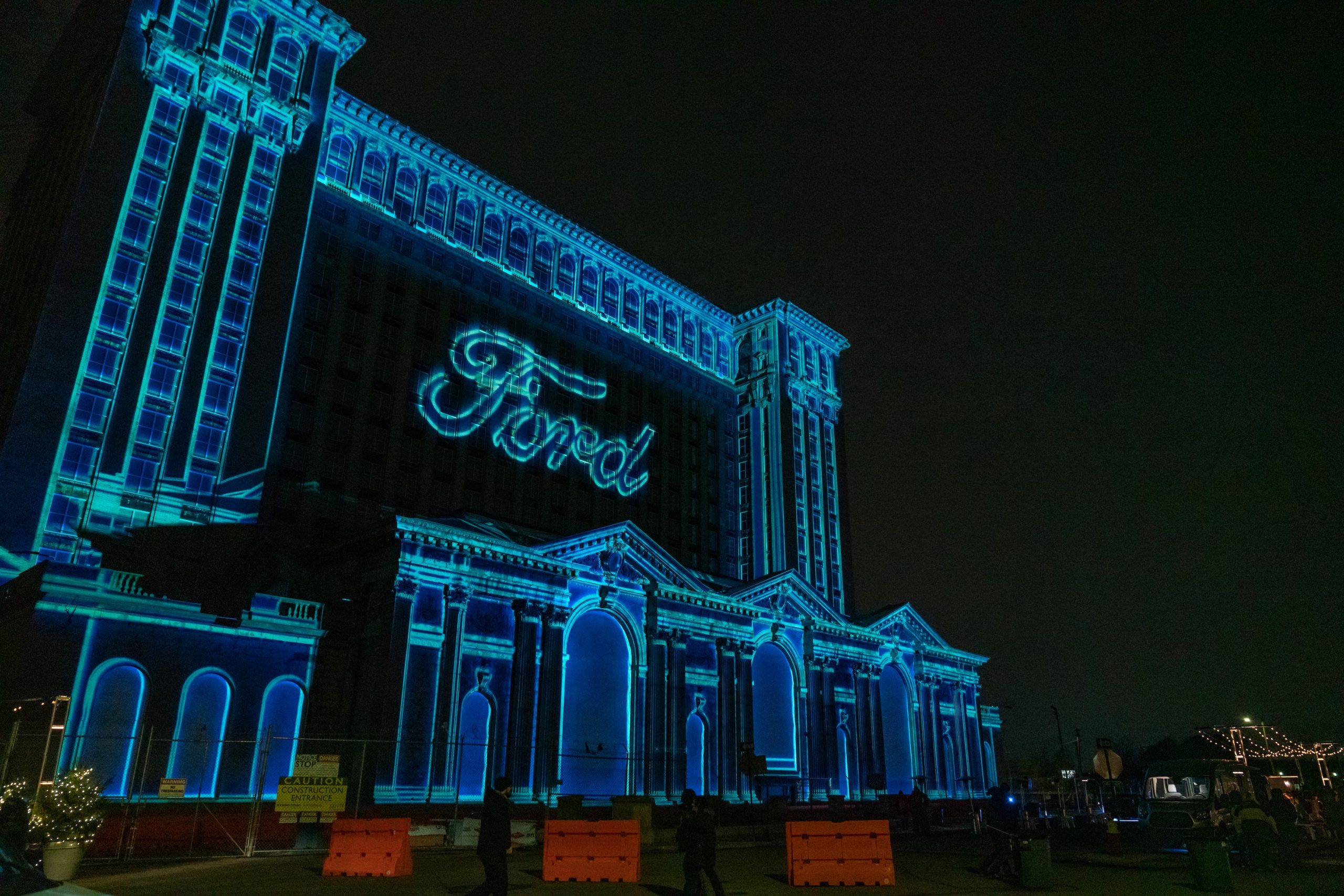 Michigan Central Station illuminated at night with Ford logo