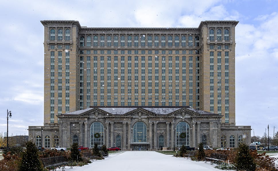 Michigan Central Station in Detroit, shown during winter with a light layer of snow on the ground.