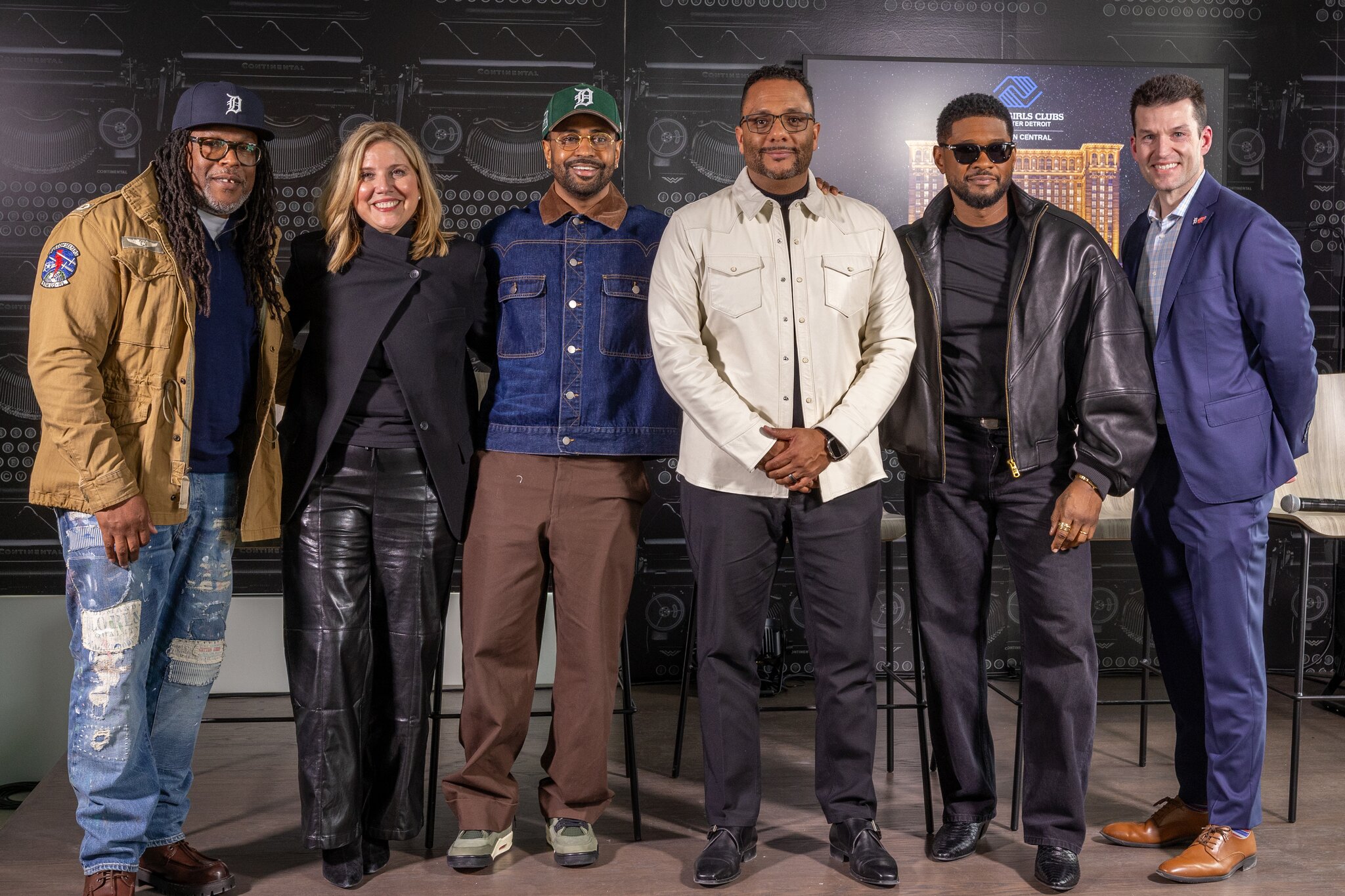 Big Sean and Usher pose with members of the Michigan Central and Boys and Girls Club of Greater Detroit Teams.